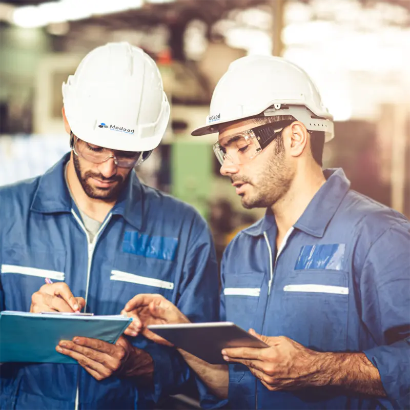 two engineers with hard hats blue taking notes on professional engineering technical services